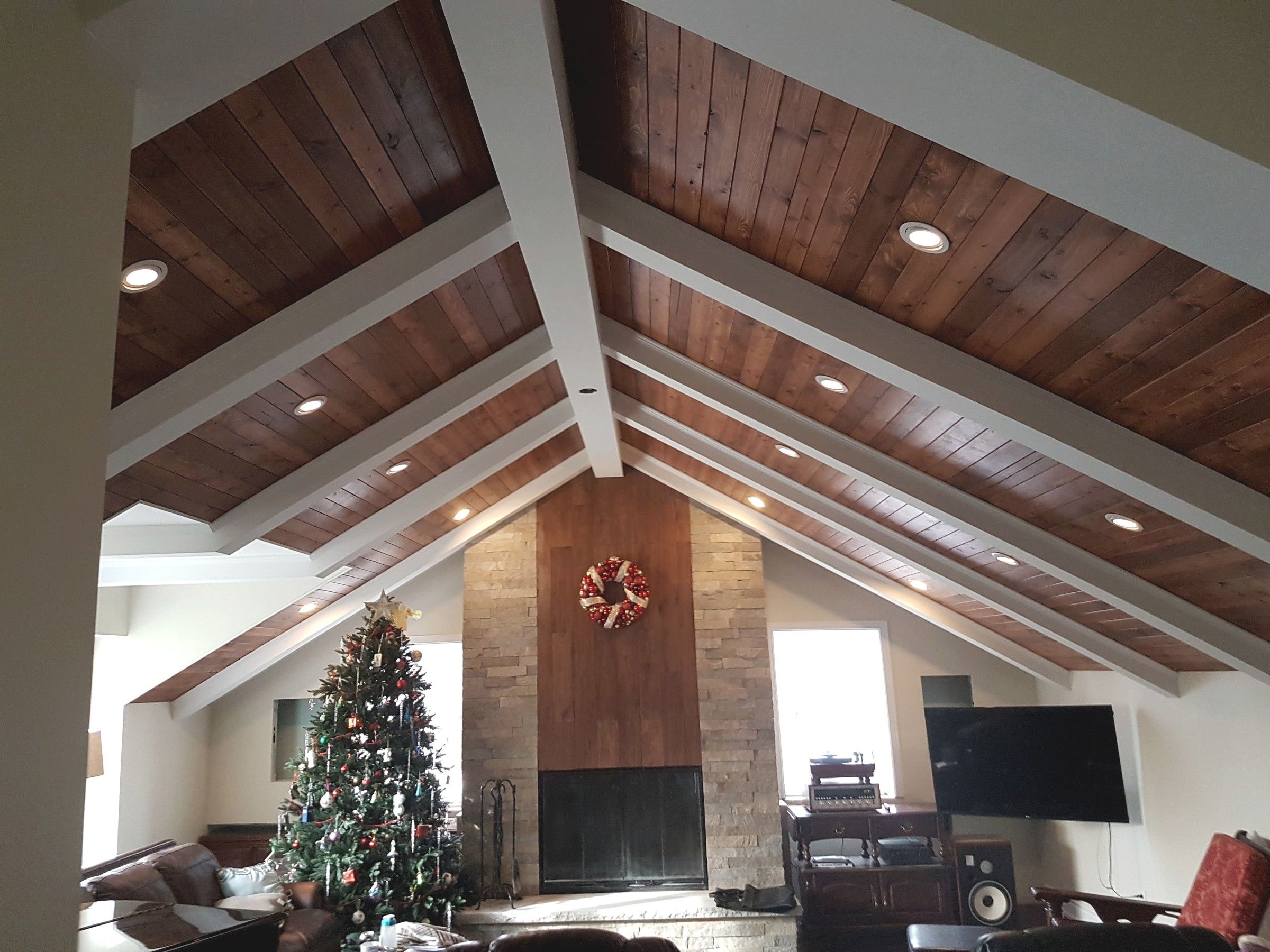 Pot lights set into a vaulted wood ceiling